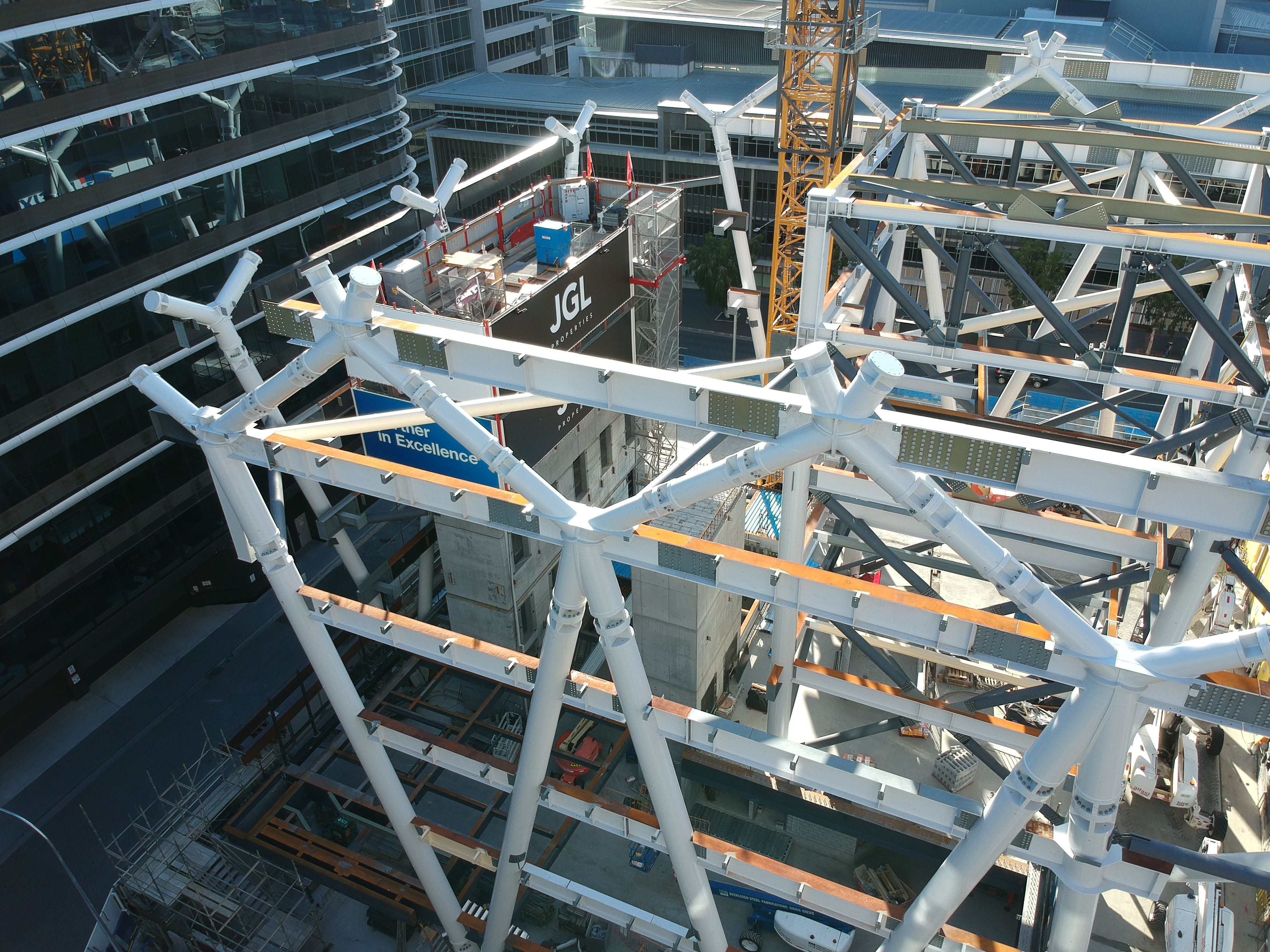 Complex white steel space frame under erection at a Brisbane commercial development